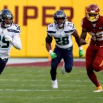LANDOVER, MARYLAND - DECEMBER 20: Free safety D.J. Reed #29 of the Seattle Seahawks runs with the ball after intercepting a Washington Football Team pass in the second half at FedExField on December 20, 2020 in Landover, Maryland. (Photo by Tim Nwachukwu/Getty Images)