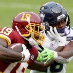 LANDOVER, MARYLAND - DECEMBER 20: Wide receiver Robert Foster #19 of the Washington Football Team stiff arms safety Ugo Amadi #28 of the Seattle Seahawks in the second half at FedExField on December 20, 2020 in Landover, Maryland. (Photo by Patrick Smith/Getty Images)