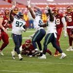 LANDOVER, MARYLAND - DECEMBER 20: The Seattle Seahawks defense celebrates after sacking quarterback Dwayne Haskins #7 of the Washington Football Team in the second half at FedExField on December 20, 2020 in Landover, Maryland. (Photo by Patrick Smith/Getty Images)