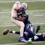 SEATTLE, WASHINGTON - DECEMBER 27: Quandre Diggs #37 and Jamal Adams #33 of the Seattle Seahawks break up a pass intended for Tyler Higbee #89 of the Los Angeles Rams during the second quarter at Lumen Field on December 27, 2020 in Seattle, Washington. (Photo by Abbie Parr/Getty Images)