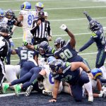 SEATTLE, WASHINGTON - DECEMBER 27: The Seattle Seahawks defense celebrates a stop on third down against the Los Angeles Rams during the third quarter at Lumen Field on December 27, 2020 in Seattle, Washington. (Photo by Abbie Parr/Getty Images)