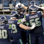 SEATTLE, WASHINGTON - DECEMBER 27:  Members of the Seattle Seahawks celebrate a touchdown by Jacob Hollister #86 against the Los Angeles Rams during the fourth quarter at Lumen Field on December 27, 2020 in Seattle, Washington. (Photo by Abbie Parr/Getty Images)