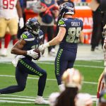 GLENDALE, ARIZONA - JANUARY 03: Wide receiver DK Metcalf #14 of the Seattle Seahawks reacts to Will Dissly #89 after a reception during the first half of the NFL game against the San Francisco 49ers at State Farm Stadium on January 03, 2021 in Glendale, Arizona. (Photo by Christian Petersen/Getty Images)
