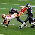GLENDALE, ARIZONA - JANUARY 03: Tight end George Kittle #85 of the San Francisco 49ers is tackled by linebacker Bobby Wagner #54, cornerback D.J. Reed Jr. #29 and safety Ugo Amadi #28 of the Seattle Seahawks during the second quarter at State Farm Stadium on January 03, 2021 in Glendale, Arizona. (Photo by Chris Coduto/Getty Images)