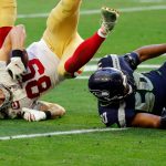 GLENDALE, ARIZONA - JANUARY 03: Linebacker K.J. Wright #50 of the Seattle Seahawks tackles tight end George Kittle #85 of the San Francisco 49ers during the second quarter at State Farm Stadium on January 03, 2021 in Glendale, Arizona. (Photo by Chris Coduto/Getty Images)