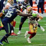 GLENDALE, ARIZONA - JANUARY 03: Quarterback C.J. Beathard #3 of the San Francisco 49ers is tackled by defensive end Benson Mayowa #95 of the Seattle Seahawks during the second quarter at State Farm Stadium on January 03, 2021 in Glendale, Arizona. (Photo by Chris Coduto/Getty Images)