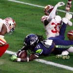 GLENDALE, ARIZONA - JANUARY 03: Running back Alex Collins #41 of the Seattle Seahawks dives in to the end zone while being tackled by defensive end Kerry Hyder Jr. #92 of the San Francisco 49ers during the fourth quarter at State Farm Stadium on January 03, 2021 in Glendale, Arizona. (Photo by Chris Coduto/Getty Images)