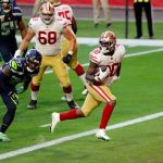 GLENDALE, ARIZONA - JANUARY 03: Running back Jeff Wilson Jr. #30 of the San Francisco 49ers scores a touchdown while being chased by safety Quandre Diggs #37 of the Seattle Seahawks during the fourth quarter at State Farm Stadium on January 03, 2021 in Glendale, Arizona. (Photo by Chris Coduto/Getty Images)
