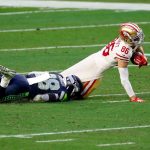 GLENDALE, ARIZONA - JANUARY 03: Safety Ugo Amadi #28 of the Seattle Seahawks tackles wide receiver River Cracraft #86 of the San Francisco 49ers during the fourth quarter at State Farm Stadium on January 03, 2021 in Glendale, Arizona. (Photo by Chris Coduto/Getty Images)