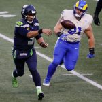 SEATTLE, WASHINGTON - JANUARY 09: Quarterback Russell Wilson #3 of the Seattle Seahawks throws a pass over defensive tackle Greg Gaines #91 of the Los Angeles Rams during the the NFC Wild Card Playoff game at Lumen Field on January 09, 2021 in Seattle, Washington. (Photo by Steph Chambers/Getty Images)
