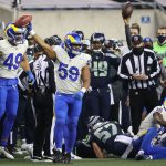 SEATTLE, WASHINGTON - JANUARY 09: Middle linebacker Micah Kiser #59 of the Los Angeles Rams celebrates recovering a fumble during the fourth quarter of the NFC Wild Card Playoff game against the Seattle Seahawks  at Lumen Field on January 09, 2021 in Seattle, Washington. (Photo by Abbie Parr/Getty Images)