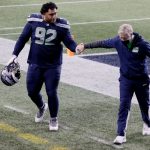 SEATTLE, WASHINGTON - JANUARY 09: Head coach Pete Carroll of the Seattle Seahawks and defensive tackle Bryan Mone #92 walk off the field after a 30-20 loss to the Los Angeles Rams in the NFC Wild Card Playoff game at Lumen Field on January 09, 2021 in Seattle, Washington. (Photo by Steph Chambers/Getty Images)