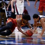 INDIANAPOLIS, INDIANA - MARCH 30: Ethan Anderson #20 of the USC Trojans and Jalen Suggs #1 of the Gonzaga Bulldogs compete for a loose ball during the first half in the Elite Eight round game of the 2021 NCAA Men's Basketball Tournament at Lucas Oil Stadium on March 30, 2021 in Indianapolis, Indiana. (Photo by Jamie Squire/Getty Images)