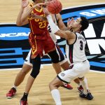 INDIANAPOLIS, INDIANA - MARCH 30: Max Agbonkpolo #23 of the USC Trojans loses the ball as he is defended by Anton Watson #22 and Andrew Nembhard #3 of the Gonzaga Bulldogs during the second half in the Elite Eight round game of the 2021 NCAA Men's Basketball Tournament at Lucas Oil Stadium on March 30, 2021 in Indianapolis, Indiana. (Photo by Andy Lyons/Getty Images)