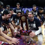 INDIANAPOLIS, INDIANA - MARCH 30: The Gonzaga Bulldogs celebrate with the West Regional Champion trophy after defeating the USC Trojans 85-66 in the Elite Eight round game of the 2021 NCAA Men's Basketball Tournament at Lucas Oil Stadium on March 30, 2021 in Indianapolis, Indiana. (Photo by Jamie Squire/Getty Images)