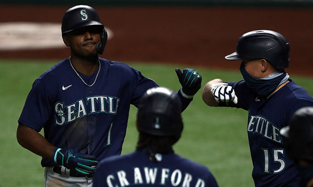 Seattle Mariners' Kyle Lewis (1) is greeted at the dugout by Taylor  Trammell, right, after Lewis hit a solo home run against the Houston Astros  during the second inning of a baseball
