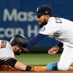 SEATTLE, WASHINGTON - APRIL 01: J.P. Crawford #3 of the Seattle Mariners tags out Evan Longoria #10 of the San Francisco Giants at second base in the fourth inning on Opening Day at T-Mobile Park on April 01, 2021 in Seattle, Washington. (Photo by Steph Chambers/Getty Images)