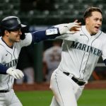 SEATTLE, WASHINGTON - APRIL 01: Luis Torrens #22 and Evan White #12 of the Seattle Mariners react after a walk-off walk by Jake Fraley #28 against the San Francisco Giants in the eleventh inning on Opening Day at T-Mobile Park on April 01, 2021 in Seattle, Washington. (Photo by Steph Chambers/Getty Images)