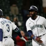 SEATTLE, WASHINGTON - APRIL 01: J.P. Crawford #3 and Taylor Trammell #20 of the Seattle Mariners react after a score against the San Francisco Giants in the eighth inning on Opening Day at T-Mobile Park on April 01, 2021 in Seattle, Washington. (Photo by Steph Chambers/Getty Images)