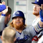 SEATTLE, WASHINGTON - APRIL 19: Justin Turner #10 of the Los Angeles Dodgers celebrates in the dugout after scoring off an RBI single by Zach McKinstry #8 during the sixth inning against the Seattle Mariners at T-Mobile Park on April 19, 2021 in Seattle, Washington. (Photo by Abbie Parr/Getty Images)