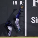 BOSTON, MASSACHUSETTS - APRIL 22: Kyle Lewis #1 of the Seattle Mariners jumps over Taylor Trammell #20 in an attempt to catch a triple hit by Enrique Hernandez #5 of the Boston Red Sox during the seventh inning at Fenway Park on April 22, 2021 in Boston, Massachusetts. (Photo by Maddie Meyer/Getty Images)