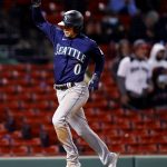 BOSTON, MASSACHUSETTS - APRIL 22: Sam Haggerty #0 of the Seattle Mariners celebrates while running towards home plate to score a run against the Boston Red Sox during the tenth inning at Fenway Park on April 22, 2021 in Boston, Massachusetts. (Photo by Maddie Meyer/Getty Images)