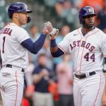HOUSTON, TEXAS - APRIL 26: Carlos Correa #1 of the Houston Astros fist bumps Yordan Alvarez #44 after Alvarez scored during the first inning against the Seattle Mariners at Minute Maid Park on April 26, 2021 in Houston, Texas. (Photo by Carmen Mandato/Getty Images)