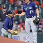 HOUSTON, TEXAS - APRIL 26: Kyle Seager #15 helps up Justus Sheffield #33 of the Seattle Mariners after Sheffield was unable to field a ball during the fifth inning against the Houston Astros at Minute Maid Park on April 26, 2021 in Houston, Texas. (Photo by Carmen Mandato/Getty Images)