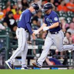 HOUSTON, TEXAS - APRIL 26: Manny Acta #14 of the Seattle Mariners high fives Kyle Seager #15 as he rounds third base after hitting a home run during the sixth inning against the Houston Astros at Minute Maid Park on April 26, 2021 in Houston, Texas. (Photo by Carmen Mandato/Getty Images)