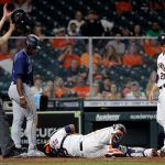 HOUSTON, TEXAS - APRIL 28: Martin Maldonado #15 of the Houston Astros lays on the plate as he was injured on the slide of Taylor Trammell #20 of the Seattle Mariners in the fourth inning as Zack Greinke #21 looks on at Minute Maid Park on April 28, 2021 in Houston, Texas. (Photo by Bob Levey/Getty Images)