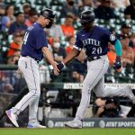 HOUSTON, TEXAS - APRIL 29: Taylor Trammell #20 of the Seattle Mariners receives congratulations from third base coach Manny Acta #14 after hitting a home run in the third inning against the Houston Astrosat Minute Maid Park on April 29, 2021 in Houston, Texas. (Photo by Bob Levey/Getty Images)