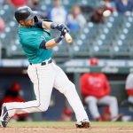 SEATTLE, WASHINGTON - APRIL 30: Mitch Haniger #17 of the Seattle Mariners hits a home run against the Los Angeles Angels in the first inning at T-Mobile Park on April 30, 2021 in Seattle, Washington. (Photo by Steph Chambers/Getty Images)