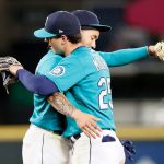 SEATTLE, WASHINGTON - APRIL 30: J.P. Crawford #3 and Dylan Moore #25 of the Seattle Mariners react after defeating the Los Angeles Angels 7-4 at T-Mobile Park on April 30, 2021 in Seattle, Washington. (Photo by Steph Chambers/Getty Images)