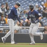 SAN DIEGO, CA - MAY 22: Mitch Haniger #17 of the Seattle Mariners, right, is congratulated by  Manny Acta #14 after hitting a solo home run during the third inning of a baseball game against the San Diego Padres at Petco Park on May 22, 2021 in San Diego, California.  (Photo by Denis Poroy/Getty Images)