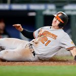 SEATTLE, WASHINGTON - MAY 03: Austin Hays #21 of the Baltimore Orioles slides safely into home plate against the Seattle Mariners during the eighth inning at T-Mobile Park on May 03, 2021 in Seattle, Washington. (Photo by Steph Chambers/Getty Images)