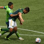 PORTLAND, OREGON - MAY 09: Raul Ruidiaz #9 of Seattle Sounders and Jose van Rankin #2 of Portland Timbers battle for possession in the first half at Providence Park on May 09, 2021 in Portland, Oregon. (Photo by Abbie Parr/Getty Images)