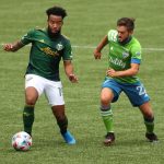 PORTLAND, OREGON - MAY 09: Eryk Williamson #19 of Portland Timbers controls the ball against Kelyn Rowe #22 of Seattle Sounders in the second half at Providence Park on May 09, 2021 in Portland, Oregon. (Photo by Abbie Parr/Getty Images)