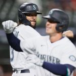 SEATTLE, WASHINGTON - MAY 13: J.P. Crawford #3 and Dylan Moore #25 of the Seattle Mariners react after Moore's two run home run against the Cleveland Indians during the eighth inning at T-Mobile Park on May 13, 2021 in Seattle, Washington. (Photo by Steph Chambers/Getty Images)