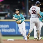 SEATTLE, WASHINGTON - MAY 14: J.P. Crawford #3 of the Seattle Mariners turns a double play past Franmil Reyes #32 of the Cleveland Indians during the second inning at T-Mobile Park on May 14, 2021 in Seattle, Washington. (Photo by Steph Chambers/Getty Images)
