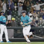 SEATTLE, WASHINGTON - MAY 14: Jarred Kelenic #10 of the Seattle Mariners reacts after a two run home run by Mitch Haniger #17 during the seventh inning against the Cleveland Indians at T-Mobile Park on May 14, 2021 in Seattle, Washington. (Photo by Steph Chambers/Getty Images)