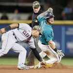 SEATTLE, WASHINGTON - MAY 14: Jarred Kelenic #10 of the Seattle Mariners slides safely into second base after his double against Cesar Hernandez #7 of the Cleveland Indians during the seventh inning at T-Mobile Park on May 14, 2021 in Seattle, Washington. (Photo by Steph Chambers/Getty Images)