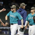 SEATTLE, WASHINGTON - MAY 14: Jarred Kelenic #10 of the Seattle Mariners shakes hands with his teammates after defeating the Cleveland Indians 7-3 at T-Mobile Park on May 14, 2021 in Seattle, Washington. (Photo by Steph Chambers/Getty Images)