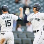 SEATTLE, WASHINGTON - MAY 15: Kyle Seager #15 and Dylan Moore #25 of the Seattle Mariners react after a three run home run by Moore during the fourth inning against the Cleveland Indians at T-Mobile Park on May 15, 2021 in Seattle, Washington. (Photo by Steph Chambers/Getty Images)