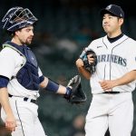 SEATTLE, WASHINGTON - MAY 17: Tom Murphy #2 and Yusei Kikuchi #18 of the Seattle Mariners meet at the pitchers mound during the first inning against the Detroit Tigers at T-Mobile Park on May 17, 2021 in Seattle, Washington. (Photo by Steph Chambers/Getty Images)