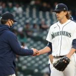 SEATTLE, WASHINGTON - MAY 19: Logan Gilbert #36 hands the game ball over to manager Scott Servais #9 of the Seattle Mariners during the third inning against the Detroit Tigers at T-Mobile Park on May 19, 2021 in Seattle, Washington. (Photo by Abbie Parr/Getty Images)