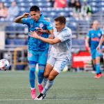 SEATTLE, WASHINGTON - MAY 30: Raul Ruidiaz #9 of Seattle Sounders and Matt Besler #5 of Austin FC collide during the first half at Lumen Field on May 30, 2021 in Seattle, Washington. (Photo by Steph Chambers/Getty Images)