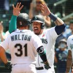 SEATTLE, WASHINGTON - MAY 31: Donovan Walton #31 is greeted by Jacob Nottingham #13 of the Seattle Mariners after hitting a three-run home run to take a 3-1 lead against the Oakland Athletics during the fourth inning at T-Mobile Park on May 31, 2021 in Seattle, Washington. (Photo by Abbie Parr/Getty Images)