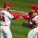 ANAHEIM, CA - JUNE 05: Alex Claudio #58 of the Los Angeles Angels is congratulated by Max Stassi #33 after pitching a scoreless ninth inning against the Seattle Mariners at Angel Stadium of Anaheim on June 5, 2021 in Anaheim, California. (Photo by Jayne Kamin-Oncea/Getty Images)