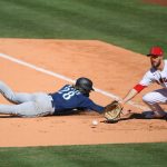 ANAHEIM, CA - JUNE 06: Jake Fraley #28 of the Seattle Mariners beat the throw to Jared Walsh #20 of the Los Angeles Angels back to first base in the ninth inning at Angel Stadium of Anaheim on June 6, 2021 in Anaheim, California. (Photo by Jayne Kamin-Oncea/Getty Images)