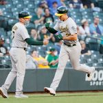 SEATTLE, WASHINGTON - JUNE 01:  Matt Olson #28 of the Oakland Athletics fist bumps third base coach Mark Kotsay #7 after Olson's home run against the Seattle Mariners during the second inning at T-Mobile Park on June 01, 2021 in Seattle, Washington. (Photo by Steph Chambers/Getty Images)
